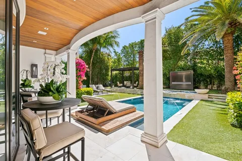 a view of a house with swimming pool and porch