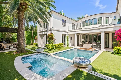a view of swimming pool with palm trees