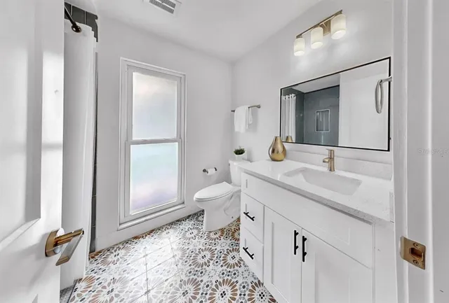 a living room with stainless steel appliances kitchen island granite countertop furniture and a view of kitchen