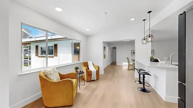 a kitchen with stainless steel appliances granite countertop a refrigerator a sink dishwasher a stove and a cabinets