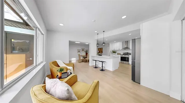 a kitchen with stainless steel appliances granite countertop a sink a stove and a refrigerator