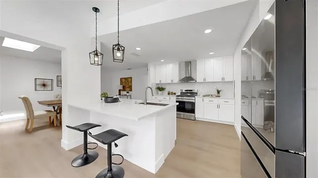 a view of a dining room with furniture and a chandelier