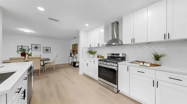 a living room with furniture and a ceiling fan