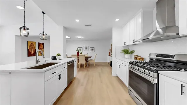 a living room with furniture a couch and large windows