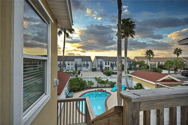 a view of a balcony with couches and wooden floor