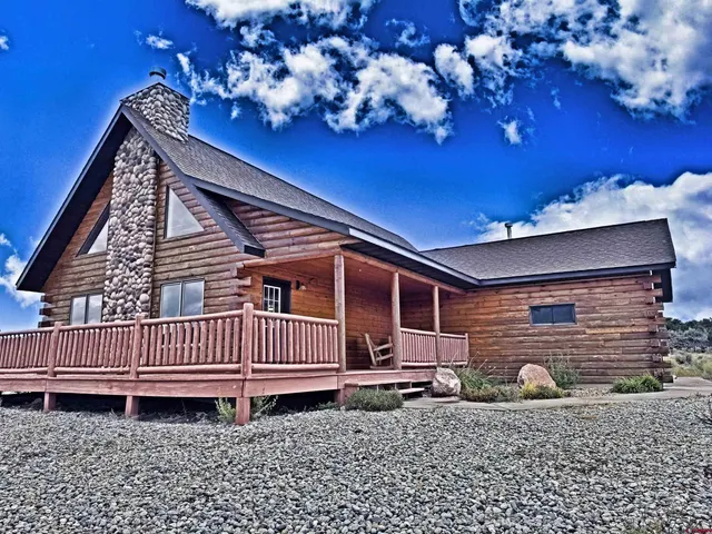 a wooden bench sitting in front of a building