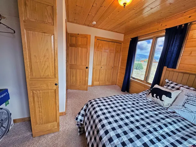 a bed sitting in a room next to a window