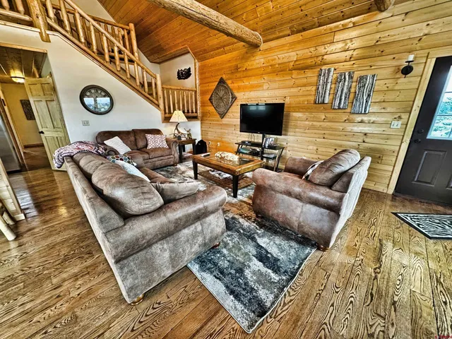 a living room with furniture a fireplace and a flat screen tv