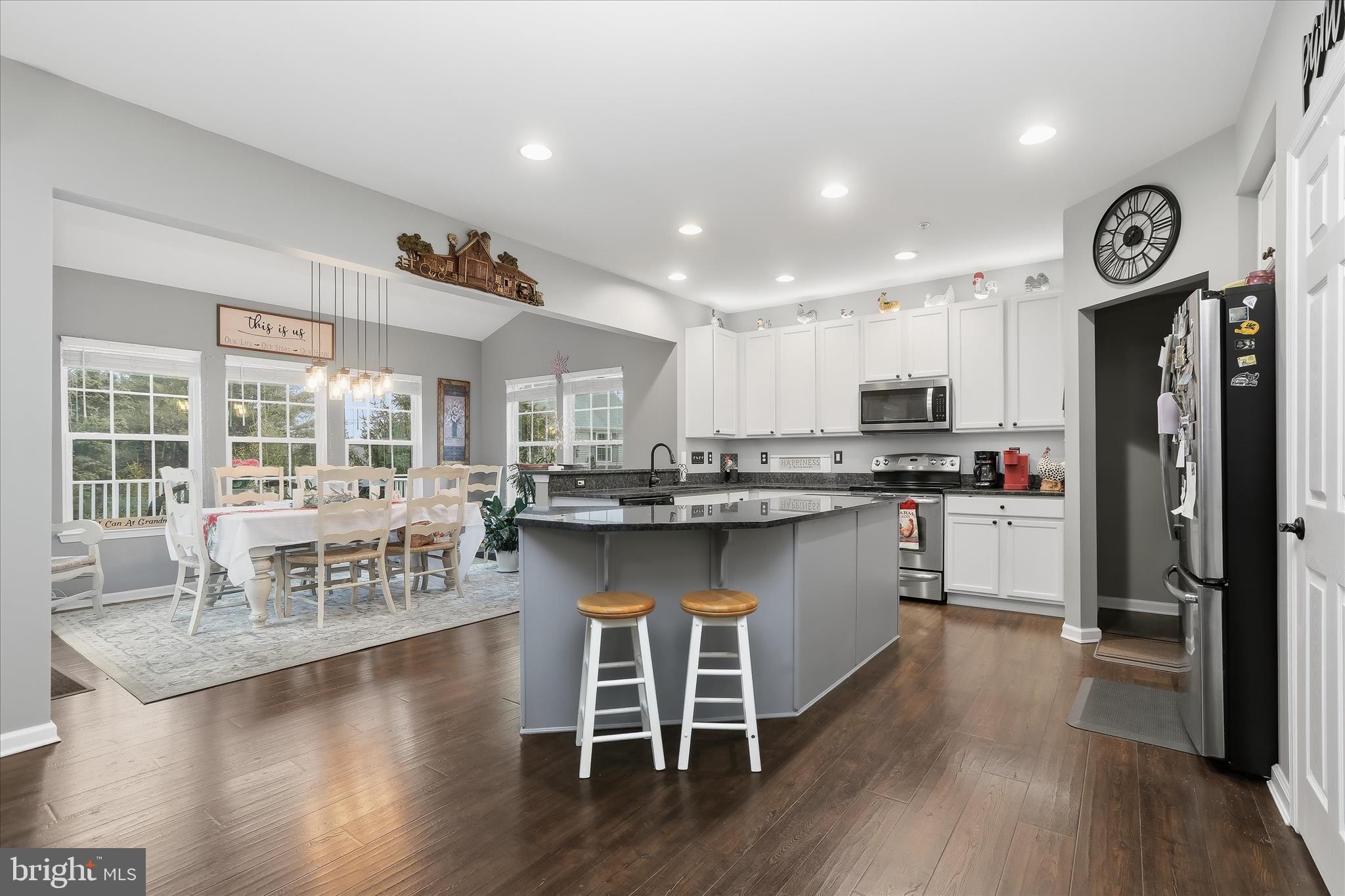 2760 Quantim Court Manchester, MD 21102 - Photo 8 of 33 a kitchen with a center island wooden floor and a clock