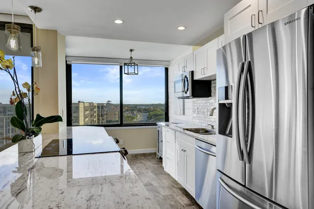 a living room with furniture kitchen and a dining table