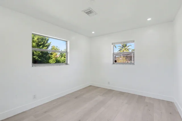 an empty room with windows and wall painting