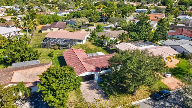 an aerial view of a houses with yard
