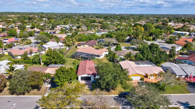 an aerial view of residential house with outdoor space and parking