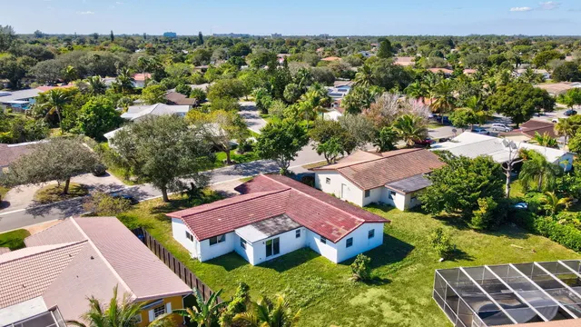 an aerial view of residential houses with outdoor space and street view
