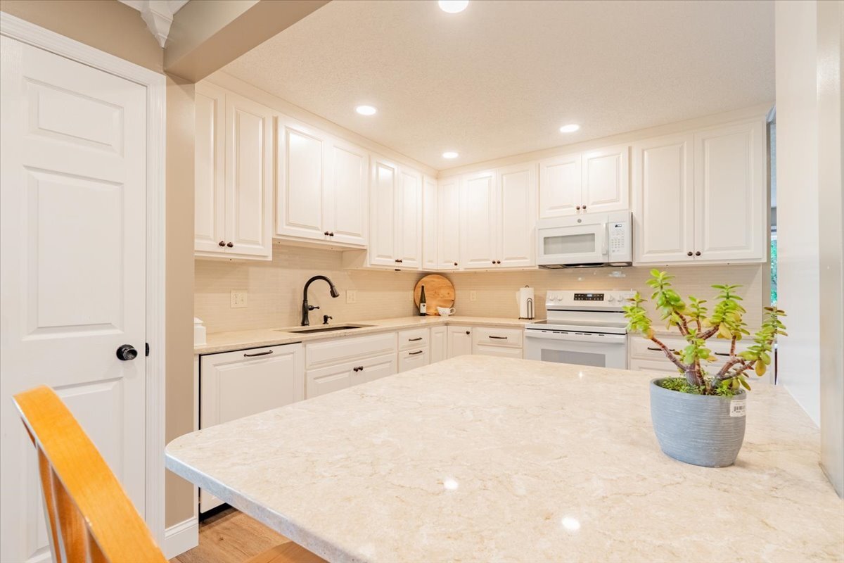 16 Holly Drive Clinton, IL 61727 - Photo 12 of 34 a kitchen with a sink a stove and white cabinets