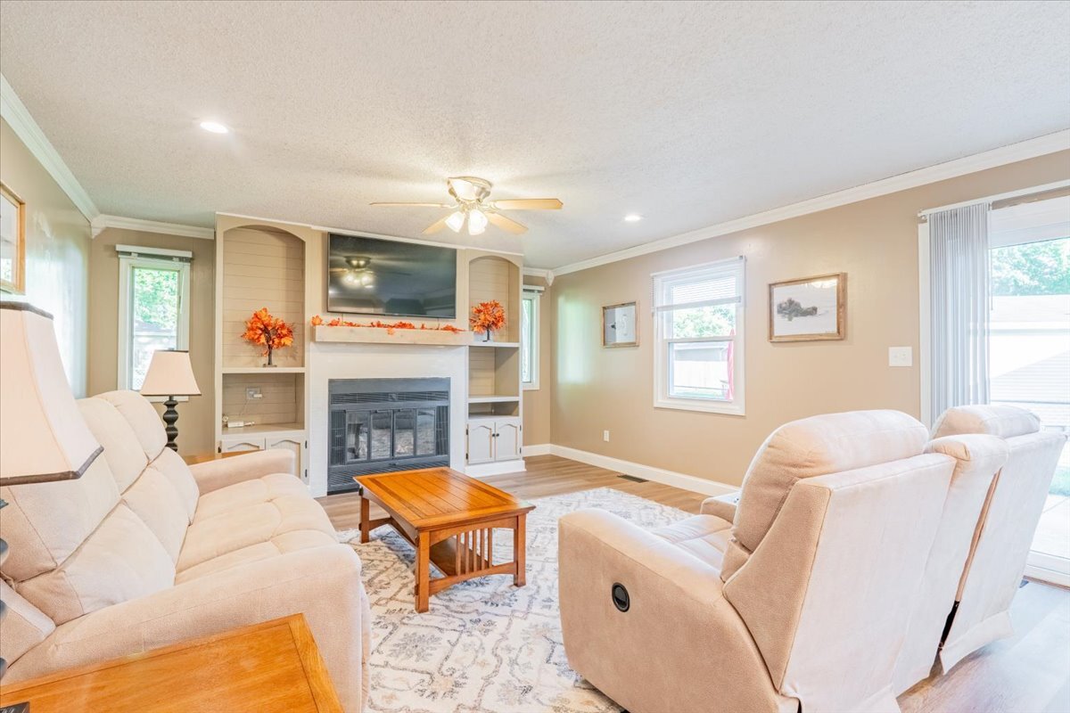 16 Holly Drive Clinton, IL 61727 - Photo 15 of 34 a living room with fireplace furniture and a flat screen tv