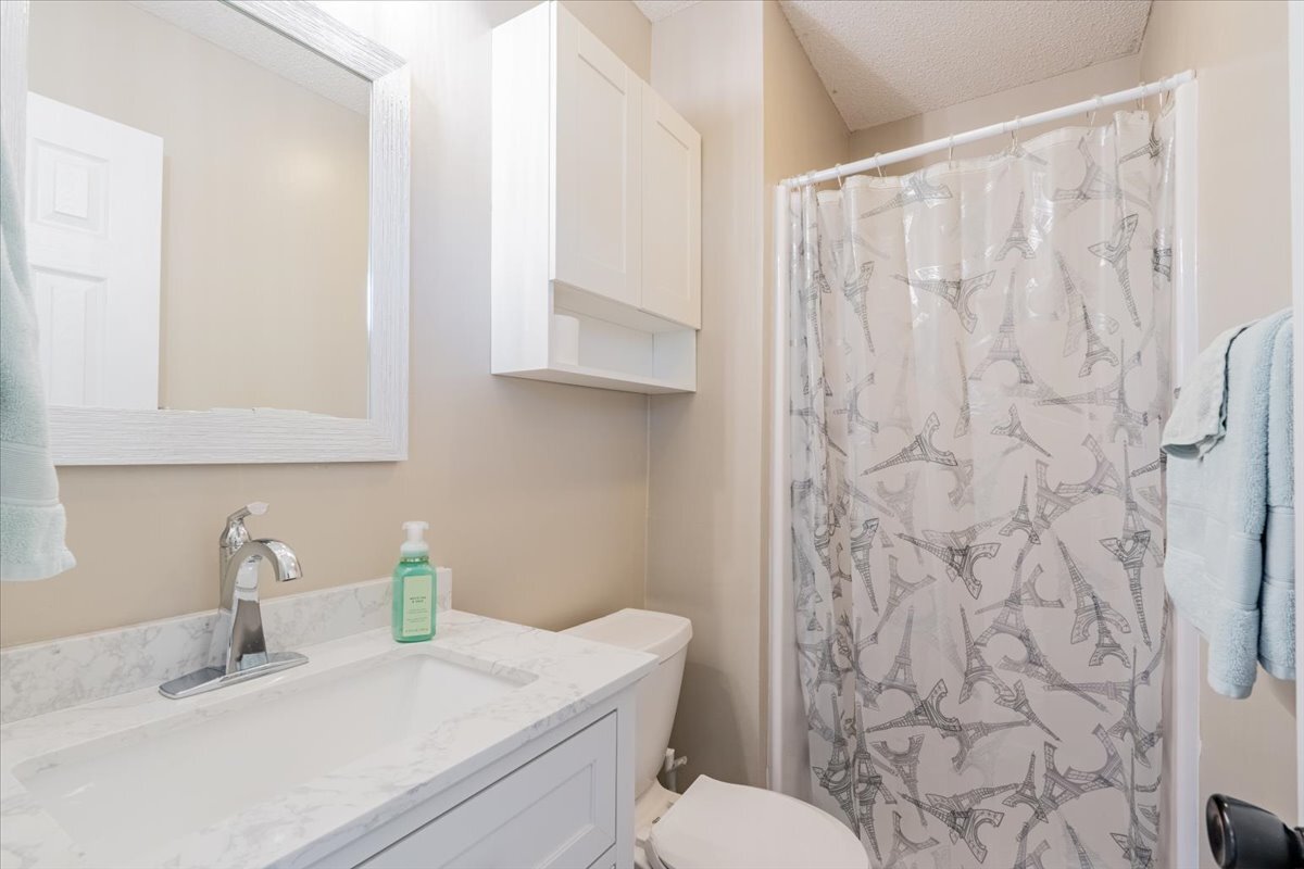 16 Holly Drive Clinton, IL 61727 - Photo 21 of 34 a bathroom with a granite countertop sink and a toilet