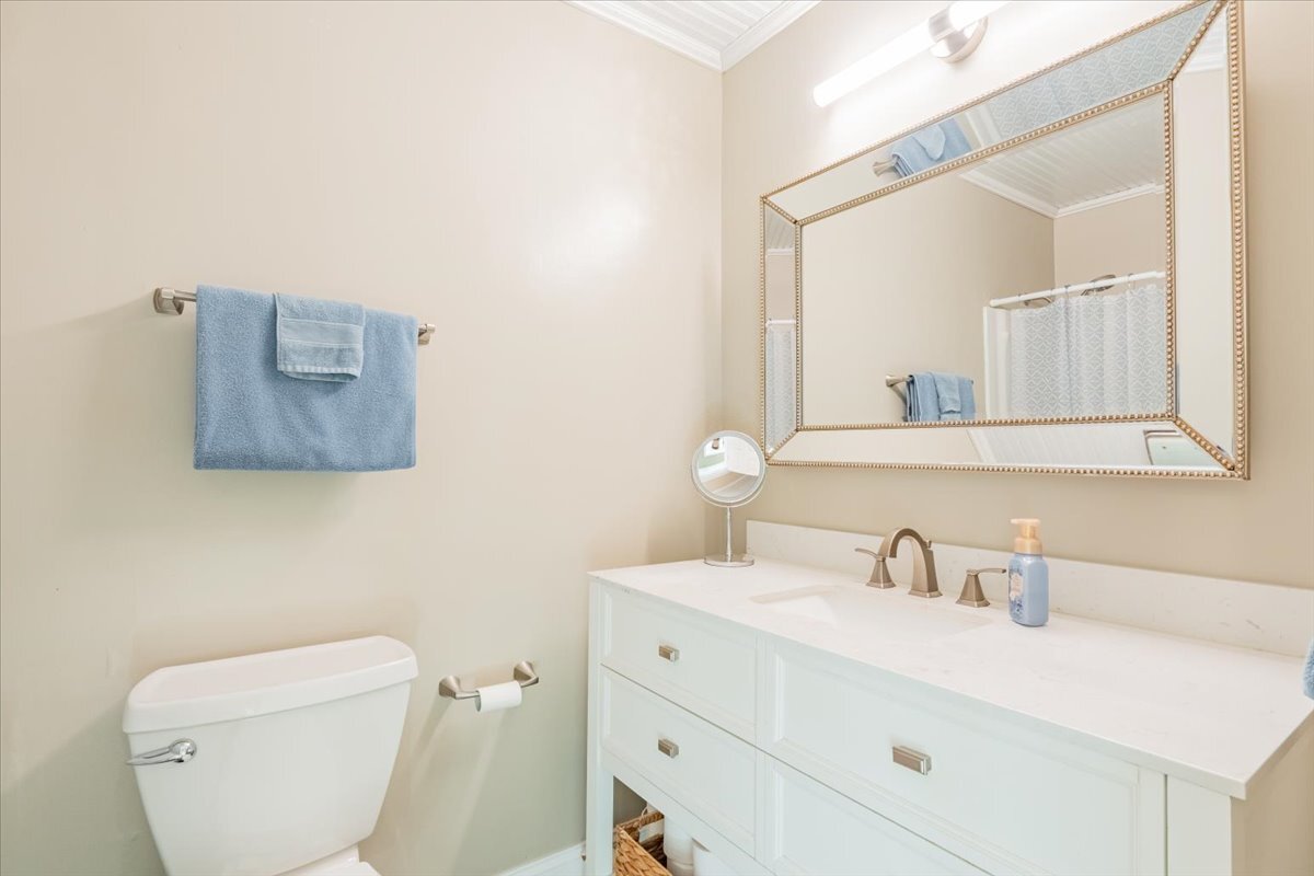 16 Holly Drive Clinton, IL 61727 - Photo 24 of 34 a bathroom with a toilet a sink and mirror