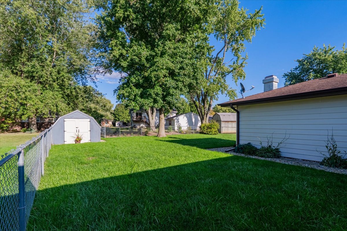 16 Holly Drive Clinton, IL 61727 - Photo 34 of 34 a view of a backyard with potted plants and large tree