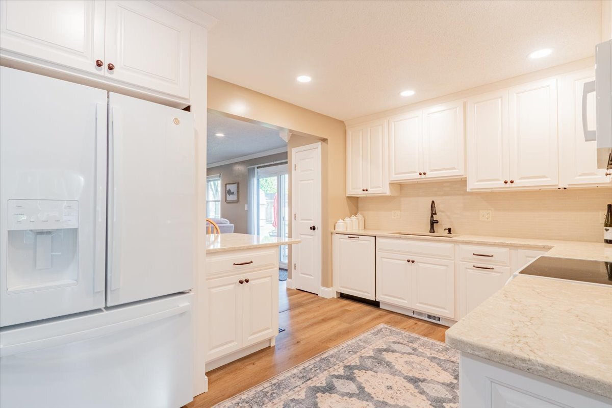 16 Holly Drive Clinton, IL 61727 - Photo 9 of 34 a large white kitchen with stainless steel appliances granite countertop a refrigerator and white cabinets