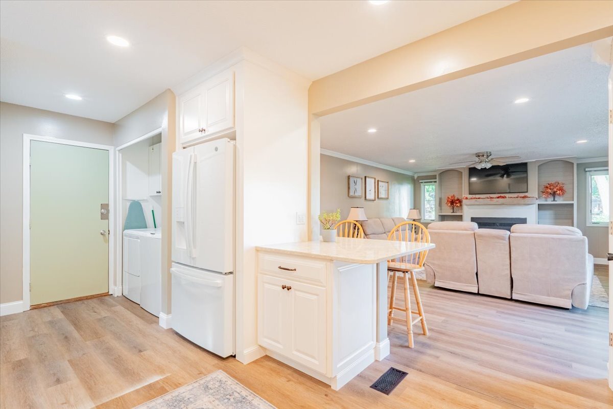16 Holly Drive Clinton, IL 61727 - Photo 10 of 34 a kitchen with white cabinets and stainless steel appliances