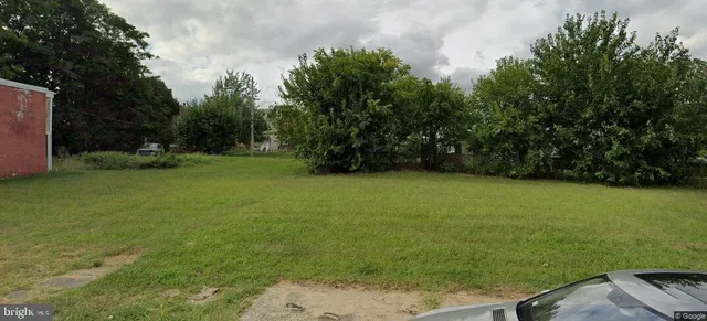 a view of a field of grass and trees