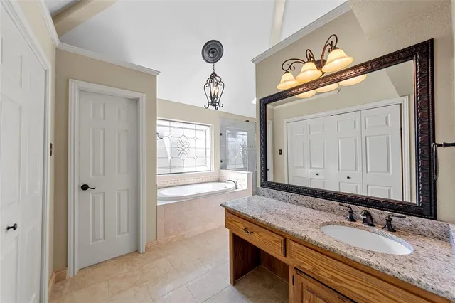 a bathroom with a granite countertop sink a mirror and a window