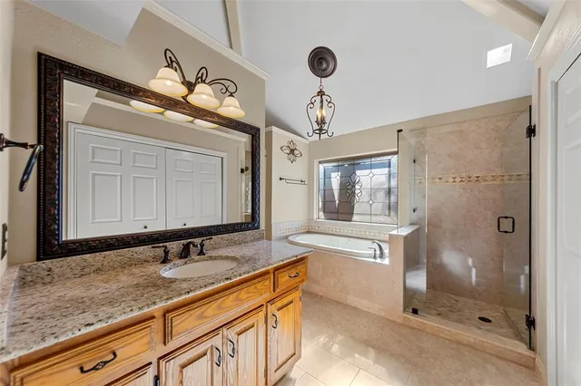 a bathroom with a granite countertop sink mirror and shower