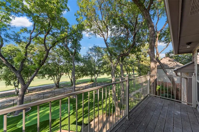 a view of balcony with wooden floor and fence