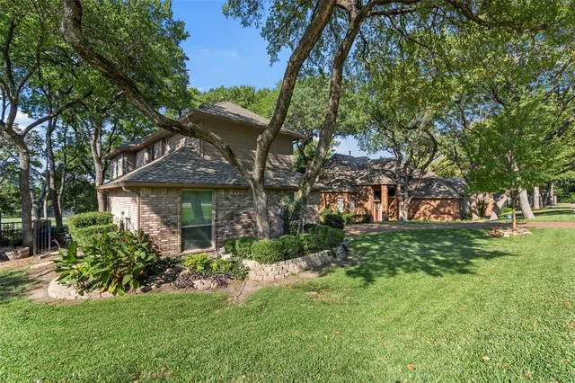 a view of house with a yard