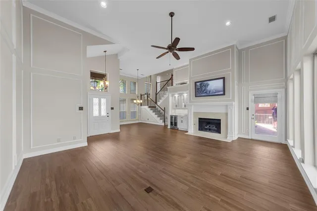 a view of a livingroom with wooden floor a fireplace and window