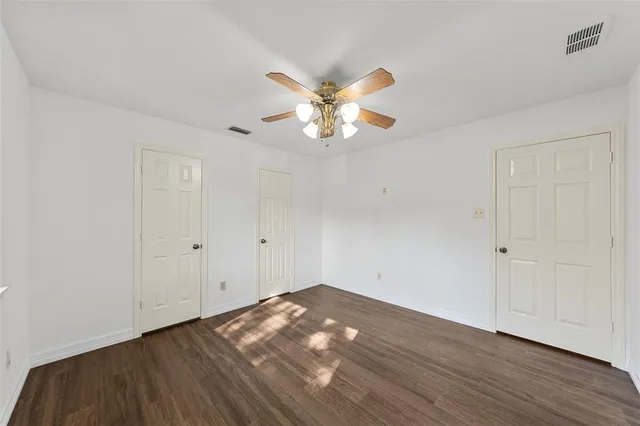 a view of an empty room and wooden floor