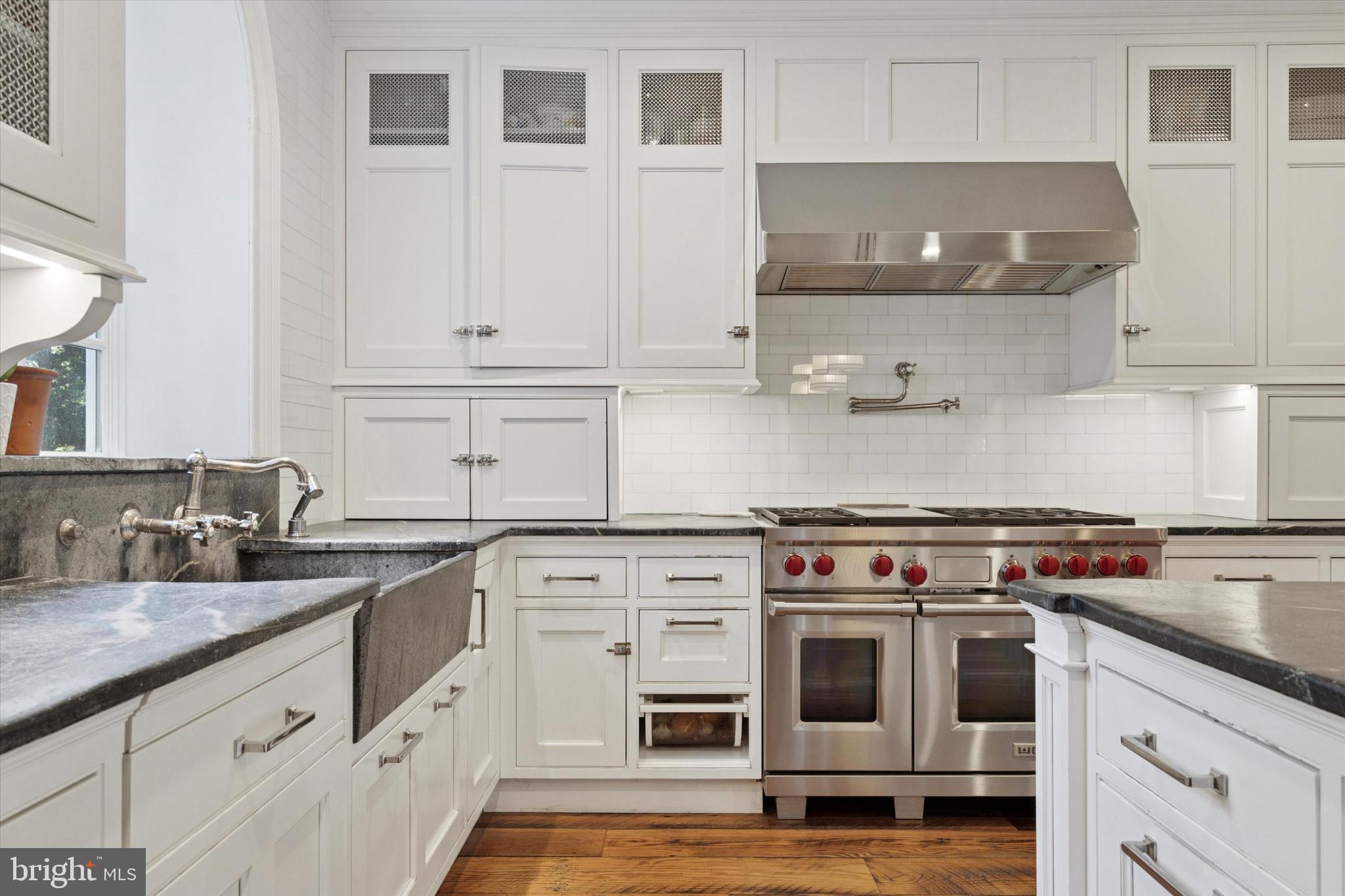 281 Winding Way Merion Station, PA 19066 - Photo 15 of 52 a kitchen with granite countertop a stove top oven and cabinets