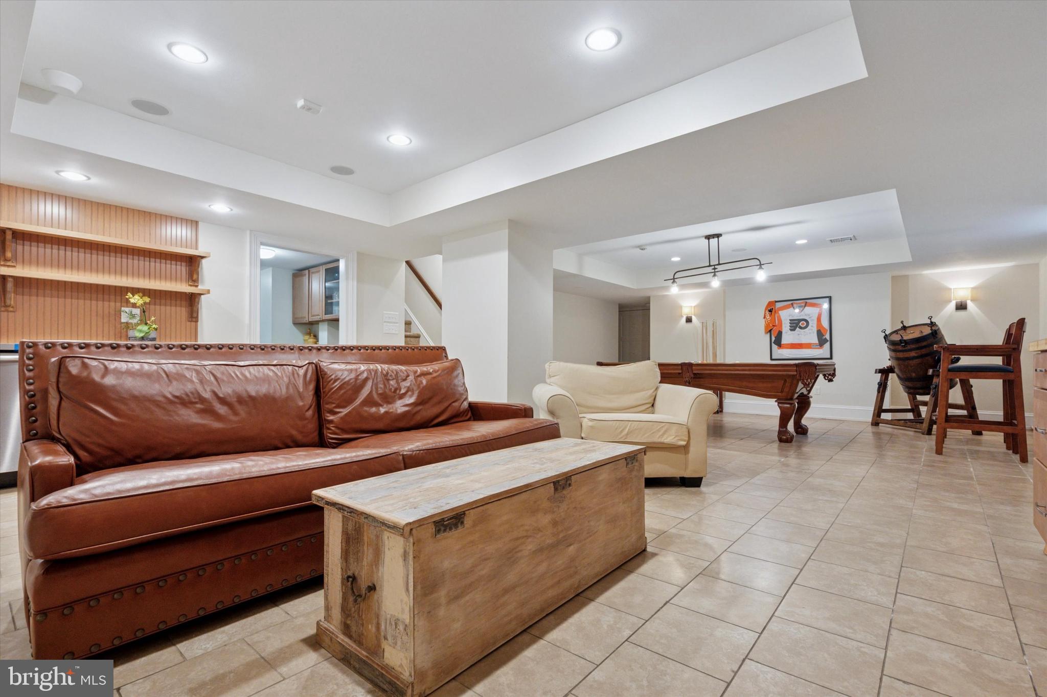 281 Winding Way Merion Station, PA 19066 - Photo 32 of 52 a living room with couches and kitchen view with wooden floor
