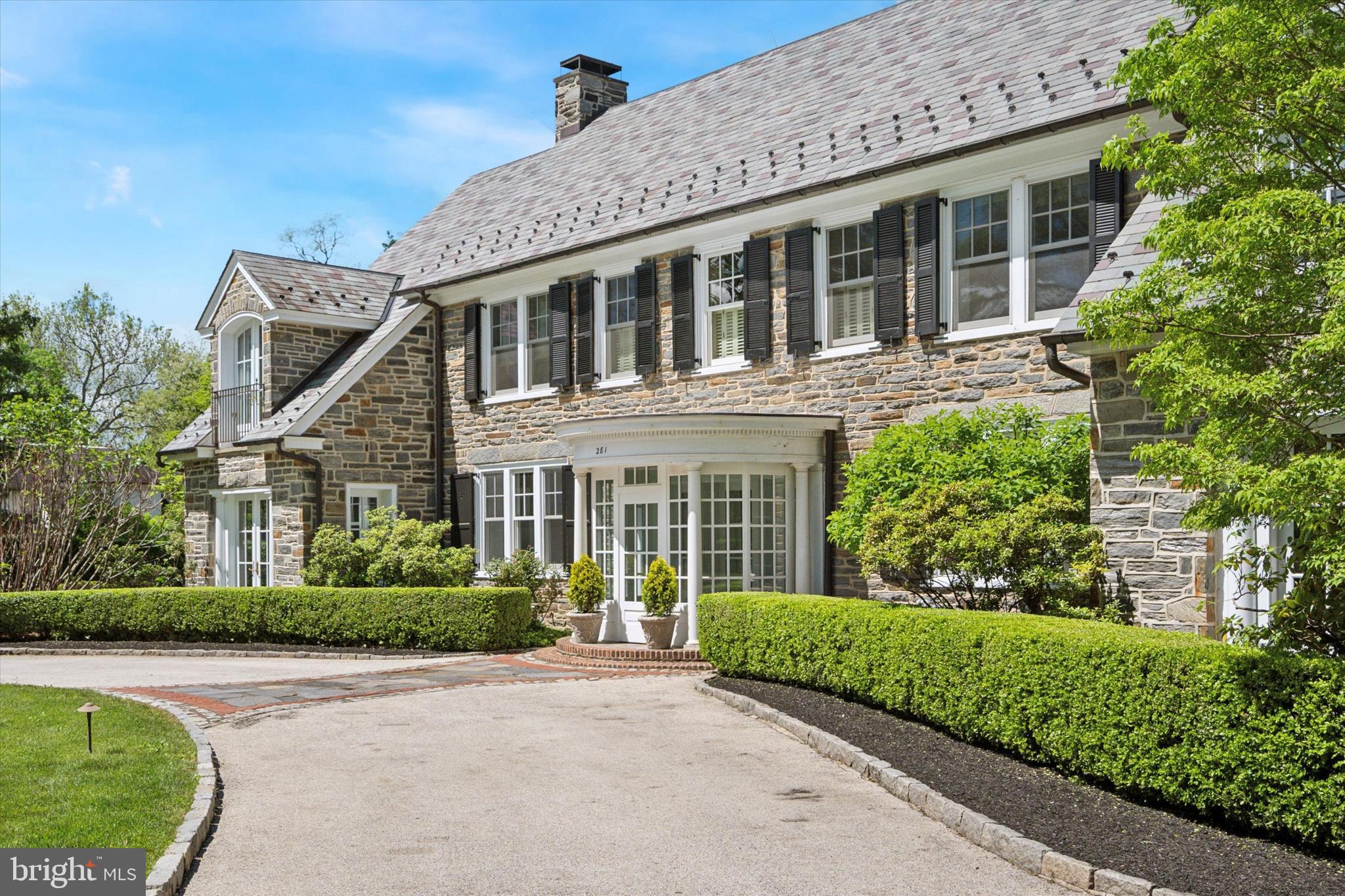 281 Winding Way Merion Station, PA 19066 - Photo 4 of 52 a front view of a house with a garden