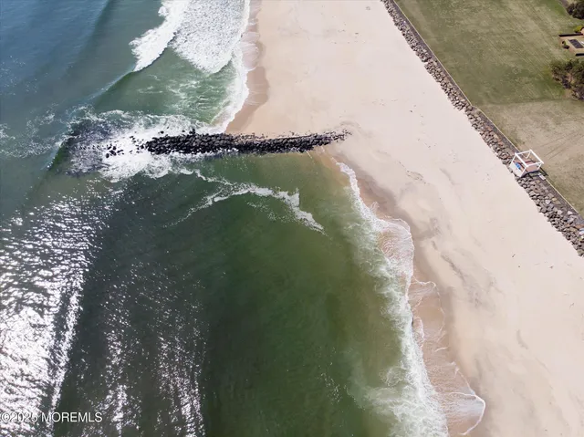 a kitchen with stainless steel appliances granite countertop a refrigerator a stove and a sink