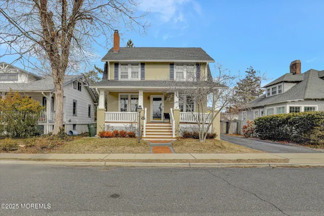 a view of a hallway with wooden floor and stairs
