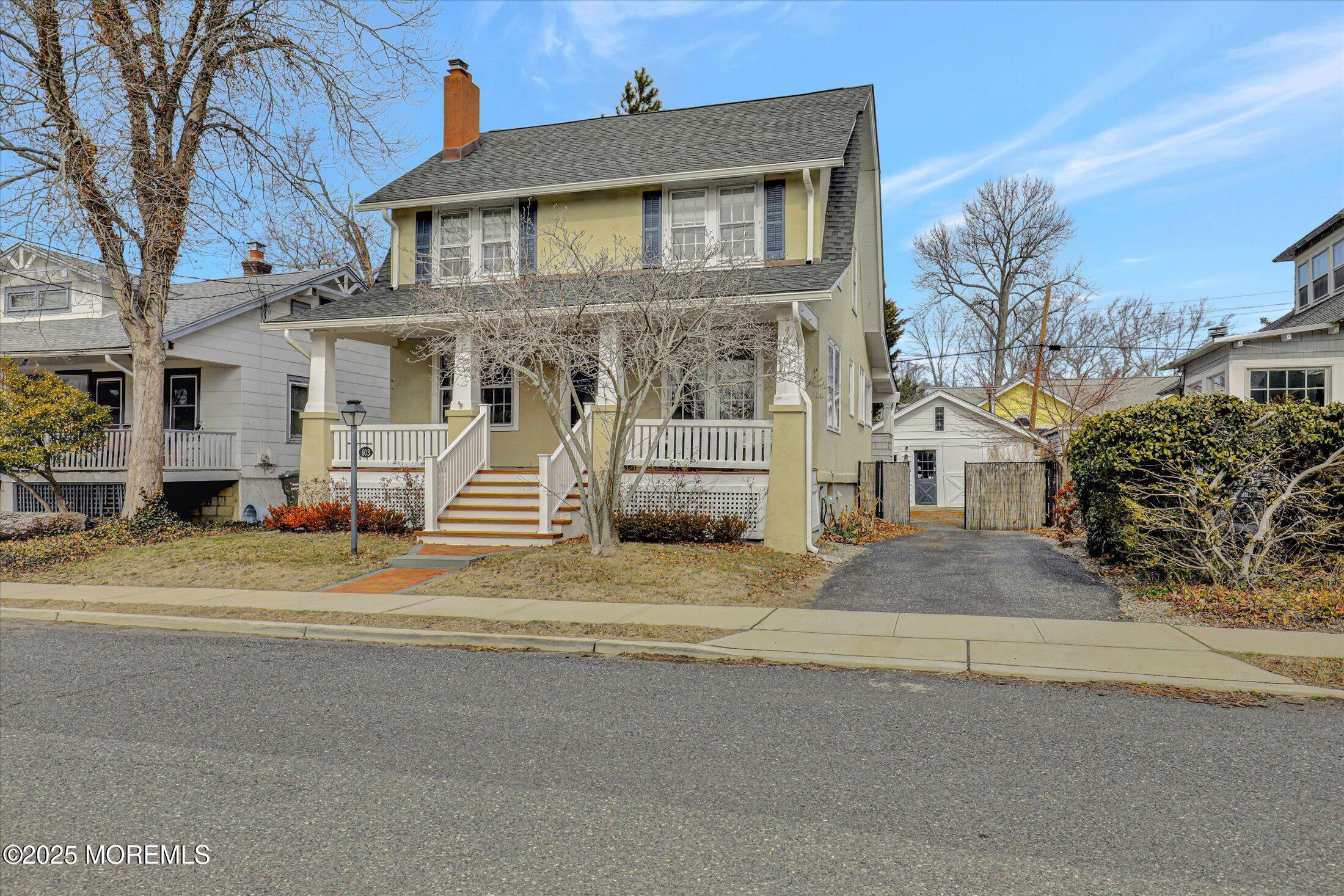603 Laurel Avenue West Allenhurst, NJ 07711 - Photo 40 of 67 a view of a brick house with a road and a yard