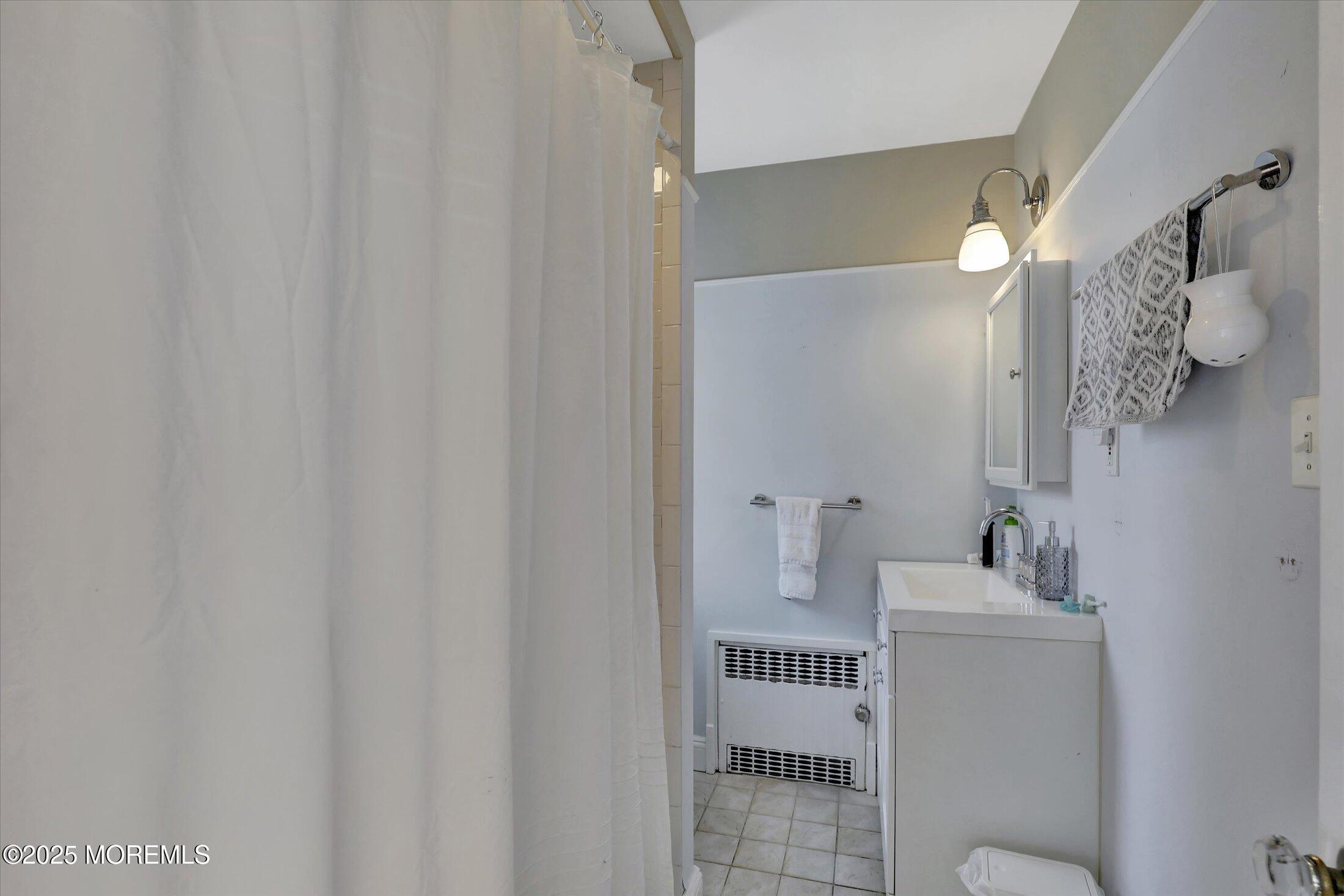 603 Laurel Avenue West Allenhurst, NJ 07711 - Photo 54 of 67 a bathroom with a sink and mirror