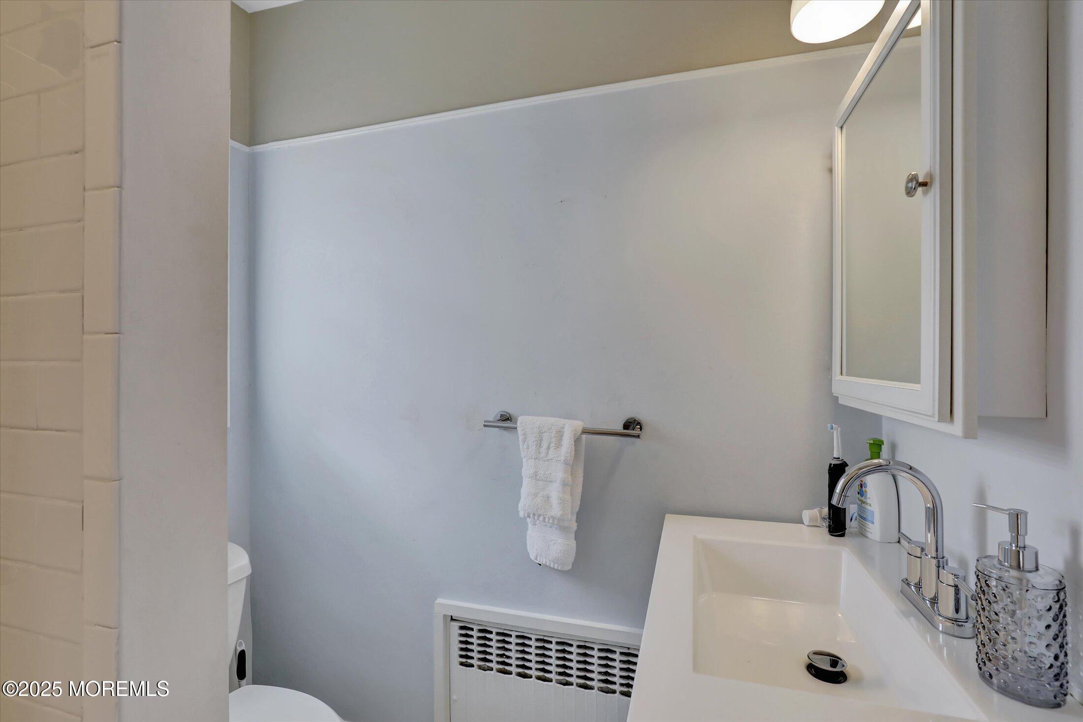 603 Laurel Avenue West Allenhurst, NJ 07711 - Photo 55 of 67 a bathroom with a sink and toilet