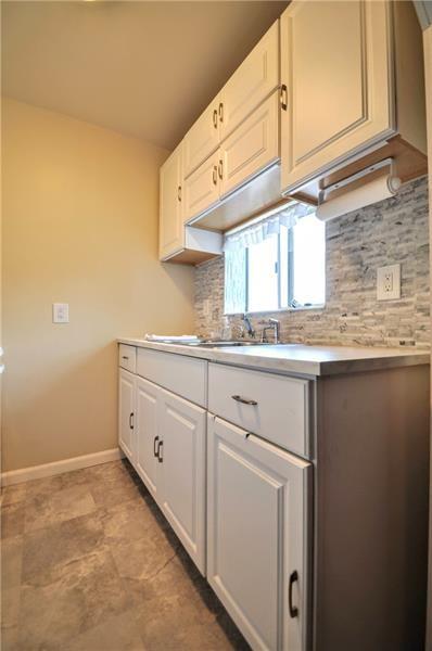 505 Noblestown Road Carnegie, PA 15106 - Photo 12 of 24 a kitchen with granite countertop white cabinets and white appliances