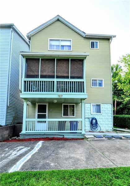 505 Noblestown Road Carnegie, PA 15106 - Photo 22 of 24 a view of a white house with large windows and a yard with plants