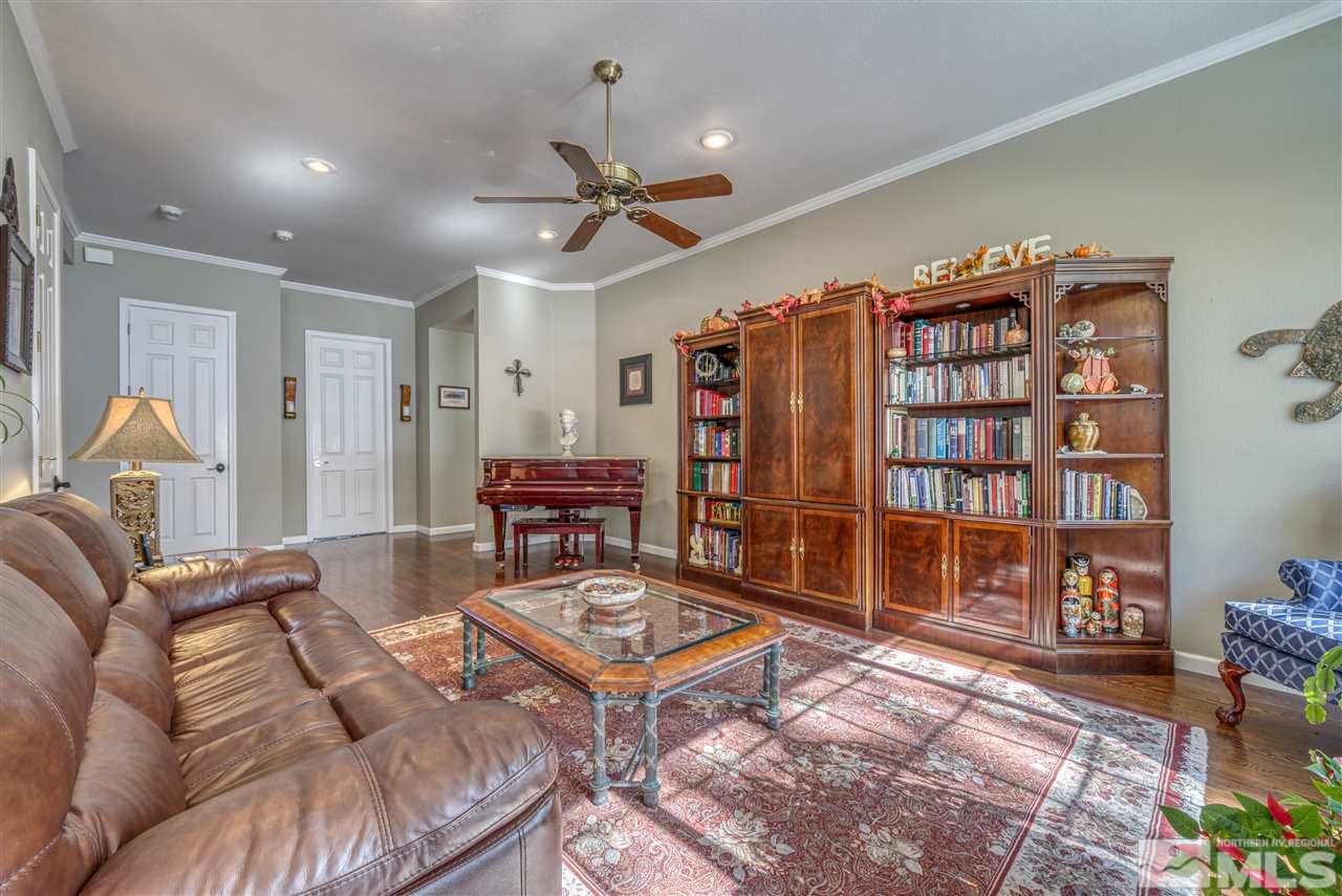 90 Sawbuck Road Reno, NV 89519 - Photo 8 of 40 a living room with furniture a rug and a bookshelf