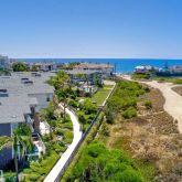 an aerial view of residential houses with outdoor space and swimming pool