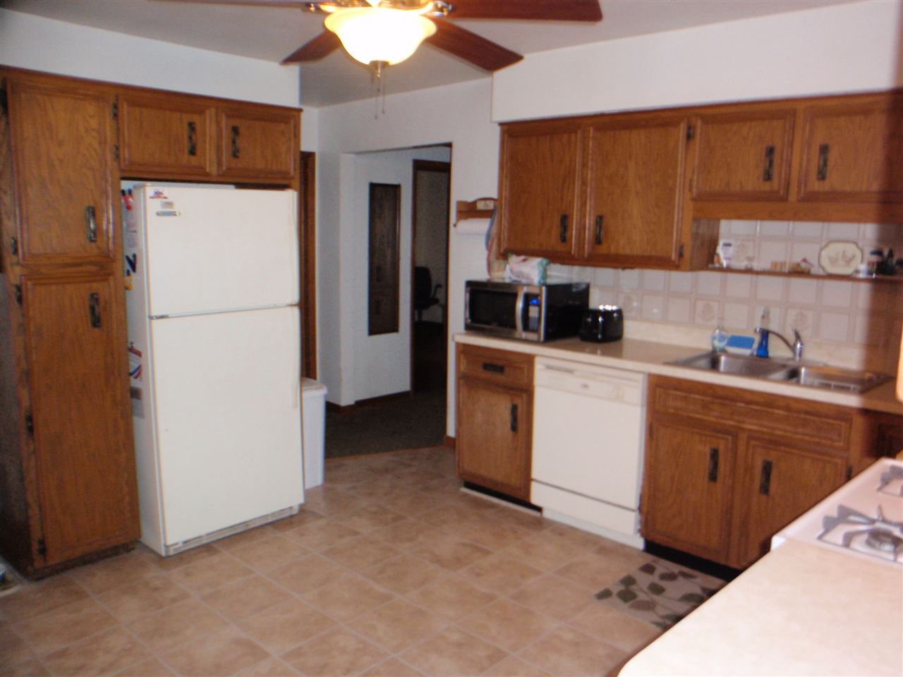 8587 Pomeroy Road Rockton, IL 61072 - Photo 4 of 20 a kitchen with a refrigerator sink stove and cabinets