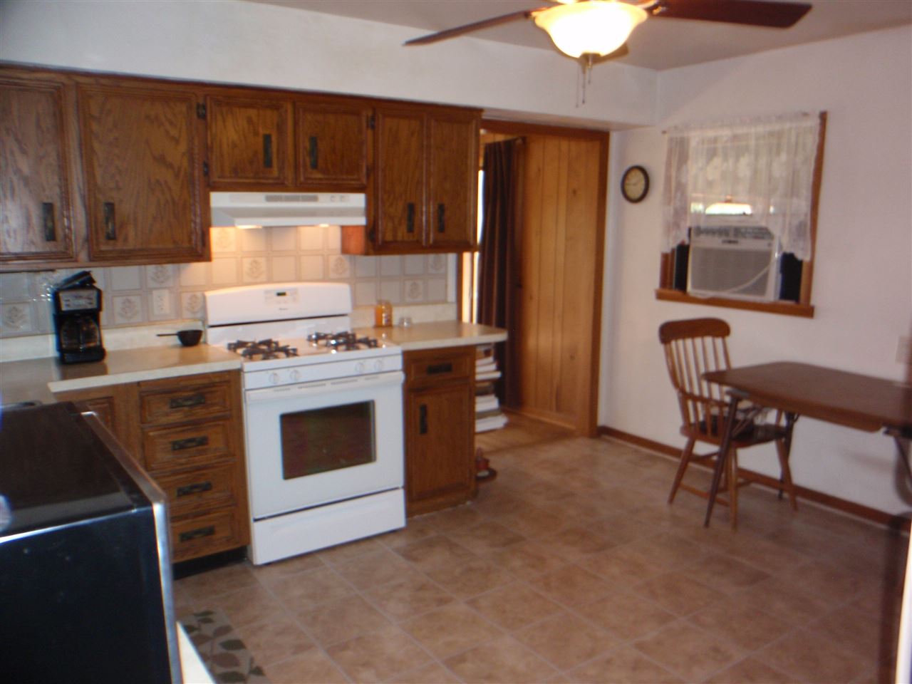 8587 Pomeroy Road Rockton, IL 61072 - Photo 5 of 20 a kitchen with a stove and a refrigerator