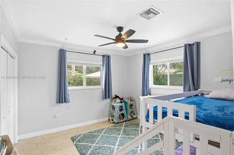 a dining room with wooden floor and a chandelier