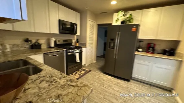 a kitchen with a refrigerator stove and sink