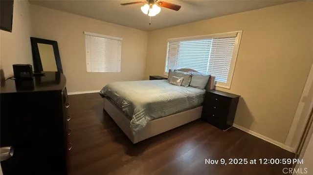 a bedroom with a bed and a flat tv screen on a dresser