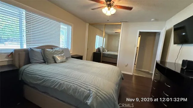 a bedroom with a bed and a chandelier